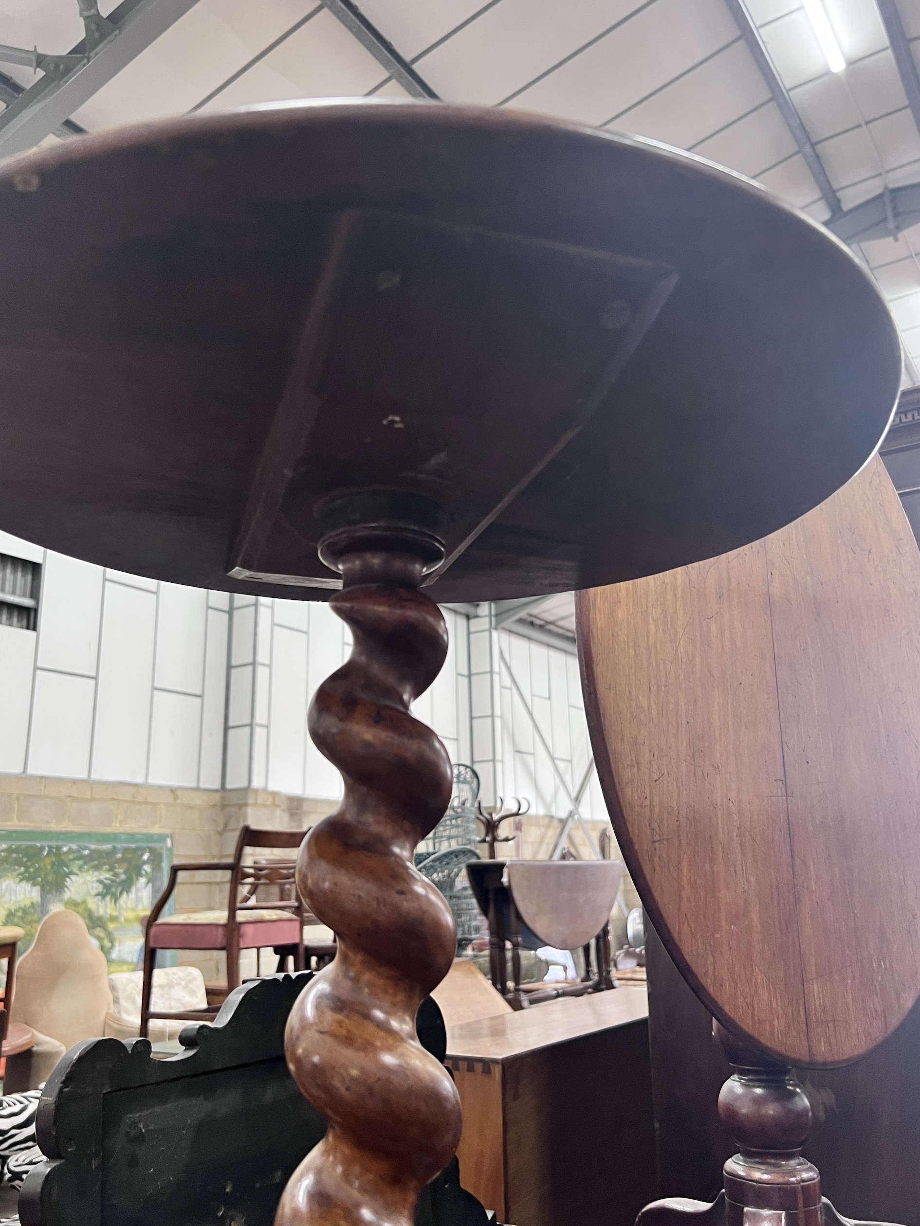 A Victorian spiral stem circular mahogany wine table, diameter 50cm, height 71cm, together with a Victorian oval mahogany tilt top tripod table